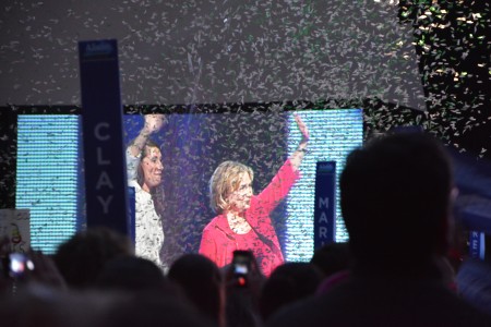 Clinton and Grimes exit the stage as confetti falls.