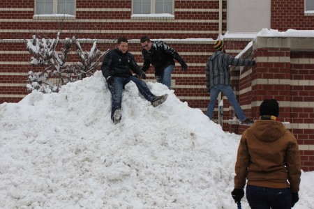 UofL students using the plowed snow as a mini hill. Photo by Samantha Crowder.