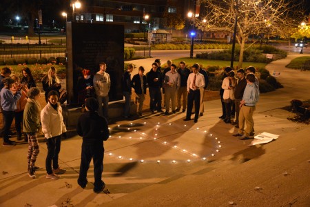 Students form a circle around the peace sign they made. 