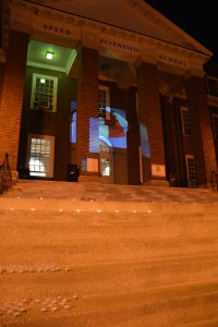 The French flag is projected on the J.B. Speed School, while the French national anthem is played during the vigil. 